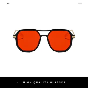 Detail of square sunglasses with vibrant red lenses and elegant gold metal hinges