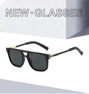 Detail of black aviator sunglasses featuring double-bridge and gold metal woven texture