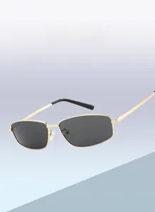 Detailed view of square vintage sunglasses with gold metal frame and dark grey lenses