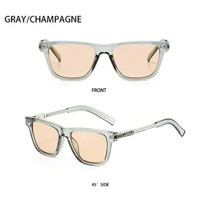Dettaglio degli occhiali da sole squadrati grigi con lenti color champagne e metallo