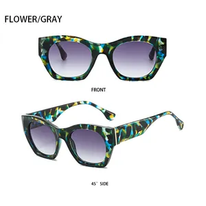 Detalle de gafas de sol con estampado floral colorido con lentes degradadas moradas y montura