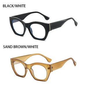 Detalle de gafas de sol cat-eye oversize en negro y marrón arena con detalles dorados