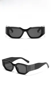 Détails de lunettes de soleil carrées avec clous argentés et verres gris foncé