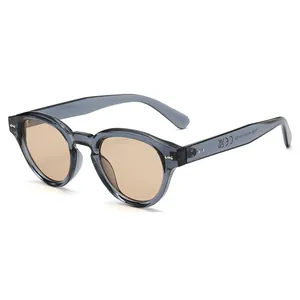 Retro round frame sunglasses in transparent grey with premium brown tinted lenses