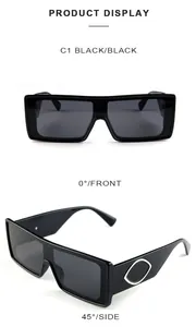 Detail of square oversized black sunglasses with gold oval temple accents in C1 black