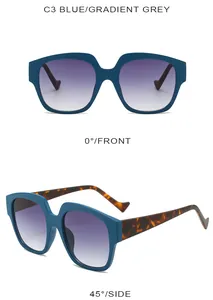 Detail view of blue oversized sunglasses with gradient grey lenses and tortoiseshell temples