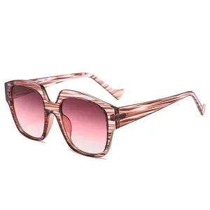 Oversized retro UV400 sunglasses for women with pink striped frames and gradient lenses