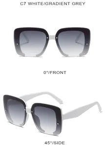 Detail view of square glitter sunglasses in white and black with gradient grey lenses