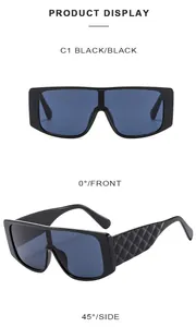 Detail view of oversized black sunglasses with quilted pattern temples and black lenses