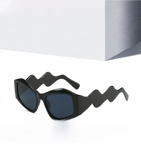Close-up of stylish black sunglasses featuring unique wavy temples and a chunky frame