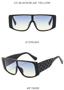 Detail of black frame sunglasses with blue yellow gradient lenses and embossed temples