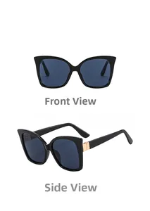 Close-up of cat-eye sunglasses with black frames and decorative gold metal buckles