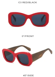 Detail of red thick frame sunglasses with dark lenses and brown wood grain temples