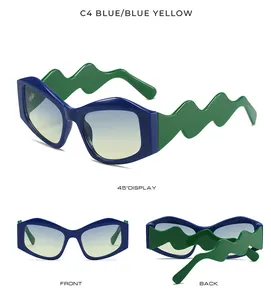Detail view of irregular sunglasses with unique wavy blue frames and green yellow lenses