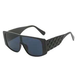 Modern oversized flat top sunglasses with black frame and quilted pattern temples