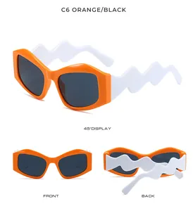 Detailed views of orange irregular sunglasses with unique white wavy temples from 45 degree angle