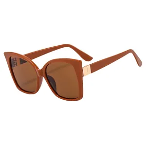 Chic caramel cat-eye sunglasses with large vintage frames and gold metal hinge accents