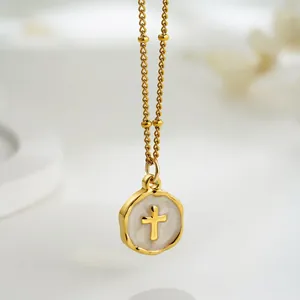 Vintage gold plated brass necklace with a cross heart pendant on white enamel