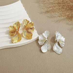 Minimalist metallic flower petal earrings in gold and silver finish with brushed texture