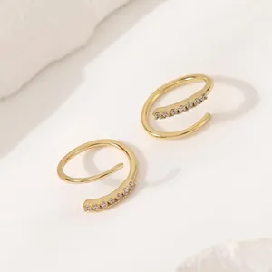 Minimalist gold cartilage hoop earrings featuring a double wrap design with clear zircons