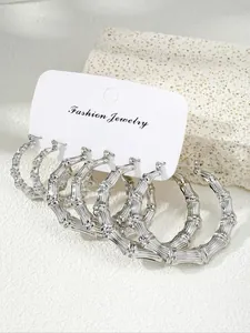 Detailed view of silver bamboo texture hoop earrings set with three pairs on display card