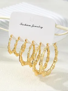 Detailed set of three golden bamboo style hoop earrings in small, medium, and large sizes