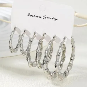 Three-pair set of silver bamboo-style hoop earrings in varied sizes on a jewelry card