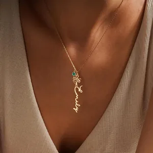 Personalized 14K gold name necklace with green birthstone and daisy flower charm