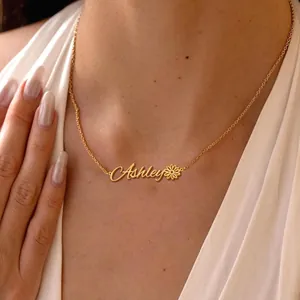 Close-up of personalized gold Ashley nameplate necklace with delicate daisy flower detail
