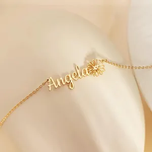 Detail of custom Angela name necklace with a daisy flower pendant in gold finish