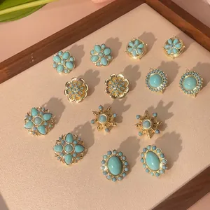 Collection of bohemian turquoise stud earrings featuring vintage gold plated brass designs