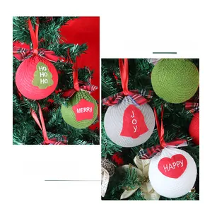 Detail of knitted Christmas tree ornaments with festive embroidery and red ribbon bows
