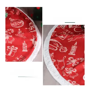 Detail of red Christmas tree skirt with white tassels and festive snowman reindeer print