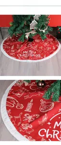 Detail of red Christmas tree skirt with white fringe and festive reindeer patterns