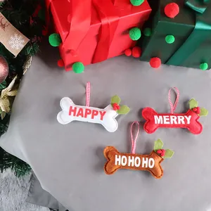 Three-piece felt dog bone Christmas ornaments set with festive holly and berry details
