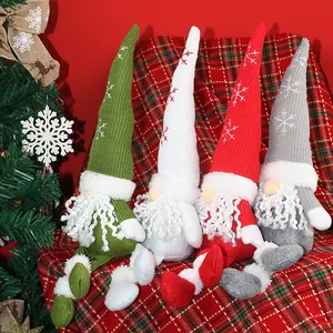 Nordic Christmas gnomes set with snowflake embroidered hats and long legs on plaid surface