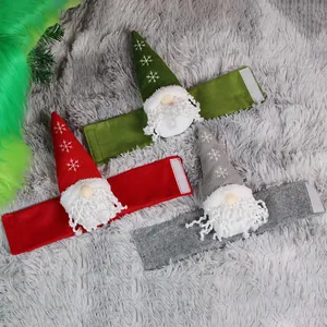 Three Christmas gnome curtain tiebacks in red, green and grey colors on plush background