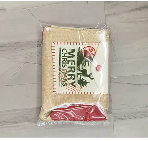 Linen Christmas gift bag with reindeer print and Merry Christmas text in plastic wrap