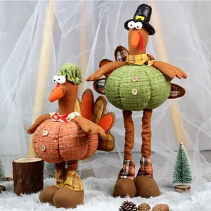 Detail of plush turkey figurines with pumpkin bodies and hats for autumn home decor