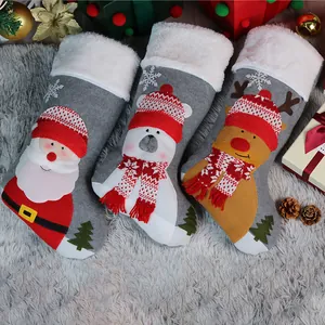 Three grey Christmas stockings with Santa, polar bear, and reindeer character designs