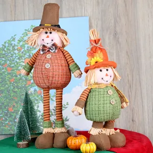 Close-up of autumn sunflower scarecrow dolls with plaid fabric and raffia leaf details