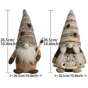 Pair of coffee gnome dolls with wooden spoon and striped hat on a white background