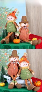 Close-up of autumn sunflower scarecrow dolls with maple leaf hats for home decor