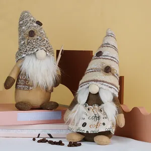 Pair of coffee-themed gnome plush dolls with knitted hats on a warm decorative setting