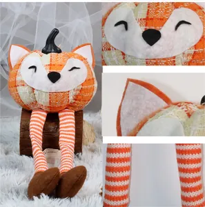 Detailed view of fox pumpkin plush with orange plaid fabric and knit dangling legs
