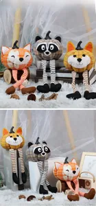 Close-up of autumn plush pumpkin dolls with long dangling legs for home decoration
