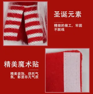 Detail of Christmas fridge handle covers showing red white stripes and Velcro closure