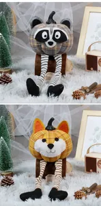 Detail of plush pumpkin dolls featuring long striped legs and cute animal face designs