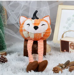 Detail of fox pumpkin doll with orange plaid fabric and long knitted hanging legs