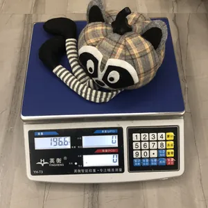 Close-up of a raccoon pumpkin plush toy on a digital scale weighing 196.6g